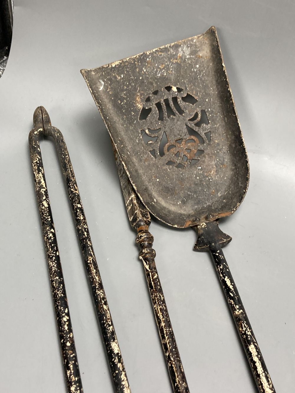 A cast iron foot scraper, width 34cm depth 32cm, a set of fire irons and fire dogs